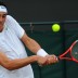 Bernard Tomic hits a backhand during his second round win at Wimbledon 2011. Getty Images