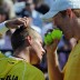 Chris Guccione (right) whispers to Lleyton Hewitt. AFP