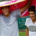Daniel Guccione (L) and Thanasi Kokkinakis try to keep dry during a rain delay in Bendigo; Tennis Australia