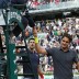 Serbia's Novak Djokovic (L) and Switzerland's Roger Federer shake hands with the umpire following their semifinal tennis match at the French Open in Paris, Djokovic won in straight sets; Getty Images