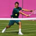 Bernard Tomic of Australia plays a volley during a practice session ahead of the 2012 London Olympic Games at Wimbledon; Getty Images