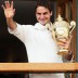 Roger Federer holds up the winner's trophy and waves to the crowd after winning the gentlemen's singles final against Andy Murray at Wimbledon; Getty Images