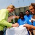 NEW YORK, NY - AUGUST 23: Kim Clijsters of Belgium signs her autograph for fans during a clinic prior to the start of the 2012 U.S. Open at the USTA Billie Jean King National Tennis Center on August 23, 2012 in the Flushing neighborhood, of the Queens borough of New York City.  (Photo by Chris Trotman/Getty Images for USTA)