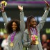 Gold medallists Serena Williams (L) and Venus Williams of the United States of the United States celebrate on the podium during the women's doubles medal ceremony; Getty Images