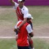 Mike Bryan (R) and Bob Bryan (L) celebrate after defeating Jo-Wilfried Tsonga and Michael Llodra of France in the men's doubles gold medal match on Day 8 of the London 2012 Olympic Games at the All England Club; Getty Images