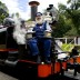 Puffing Billy train driver Gary poses with the Australian Open trophies as part of the Australian Open trophy tour's stop in Belgrave, Victoria; Bek Johnson