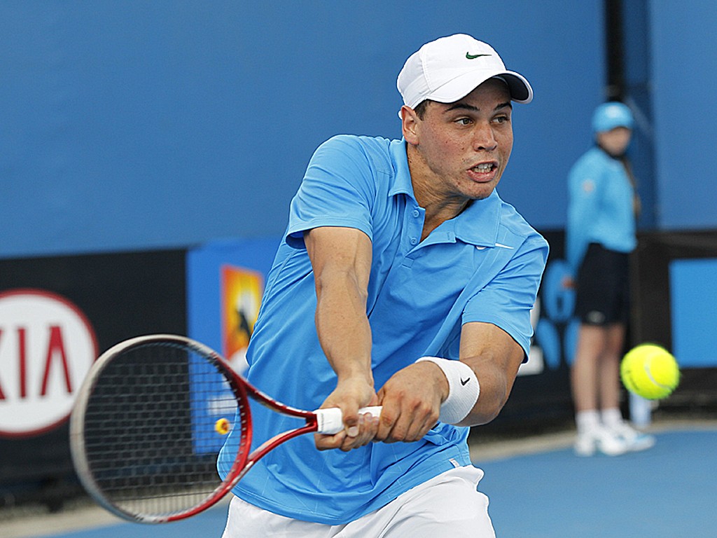 Aussie Alex Bolt plays a backhand in his match against Frenchman Florent Serra on Day 2 of Australian Open 2013 Qualifying.