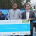 Nick Kyrgios (L) receives the winning cheque from Nature's Way brand manager Adam Browne after triumphing at the Nature's Way Sydney Tennis International Challenger event; Tennis Australia