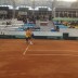 Bernard Tomic plays a backhand during his reverse singles rubber win over Denis Istomin; Tennis Australia