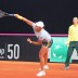 Ash Barty serves during a practice session, as captain Alicia Molik watches on, ahead of Australia's Fed Cup tie against Switzerland in Chiasso; Tennis Australia