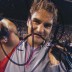 Roger Federer signs a camera plate after winning a match on Rod Laver Arena at Australian Open 2013; Tennis Australia