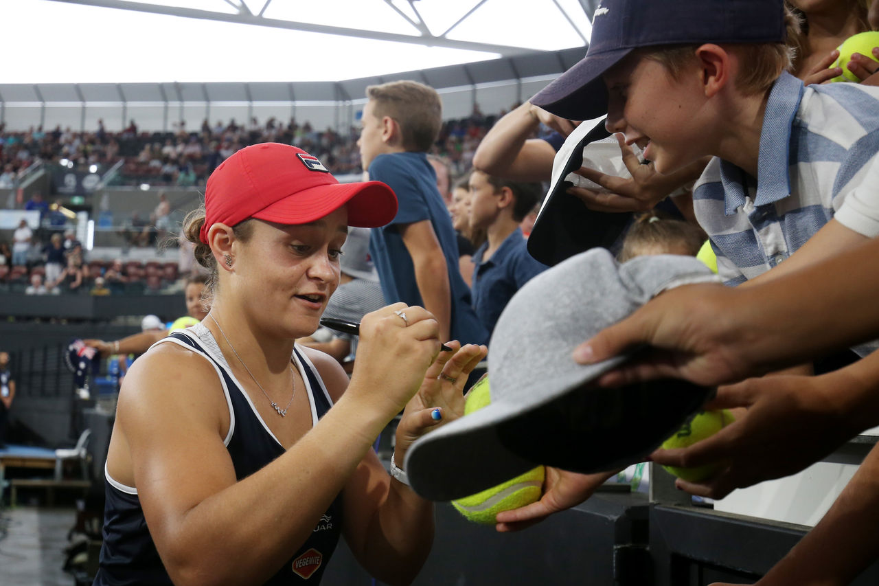 BRISBANE, AUSTRALIA - JANUARY 12: Ashleigh Barty of Australia signs autographs after her doubles final match partnered with Kiki Bertens of the Netherlands against Hsieh Su-wei of Taiwan and Strycova Barbora of the Czech Republic during day seven of the 2020 Brisbane International at Pat Rafter Arena on January 12, 2020 in Brisbane, Australia. (Photo by Chris Hyde/Getty Images)