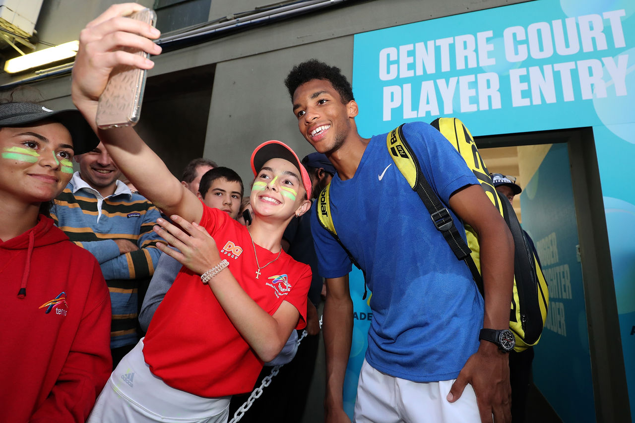 ADELAIDE, AUSTRALIA - JANUARY 15: Felix Auger-Aliassime of Canada poses for selfies with after winning his singles match against James Duckworth of Australia during day four of the 2020 Adelaide International at Memorial Drive on January 15, 2020 in Adelaide, Australia. (Photo by Paul Kane/Getty Images)