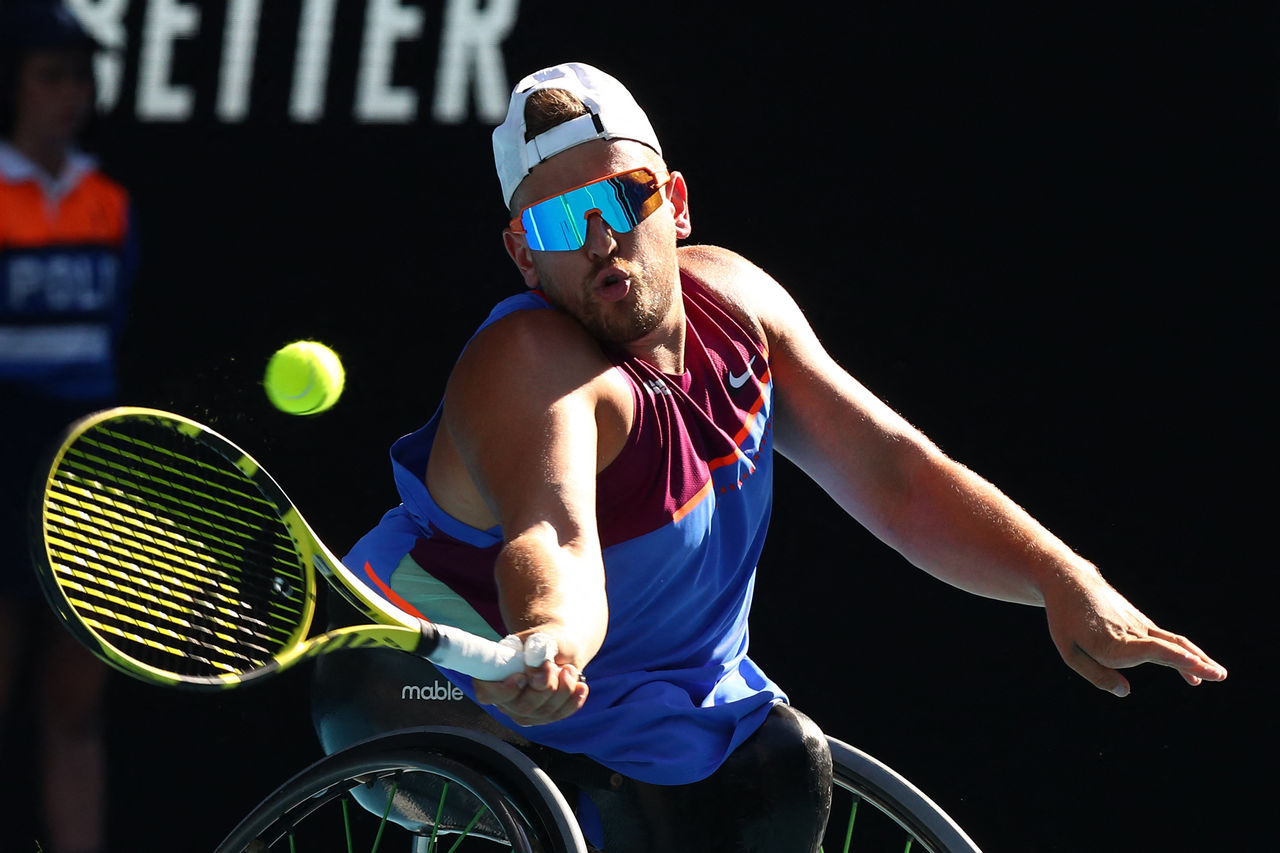 Australia's Dylan Alcott hits a return against Netherlands' Sam Schroder during their men's quad wheelchair singles final match on day eleven of the Australian Open tennis tournament in Melbourne on January 27, 2022. - -- IMAGE RESTRICTED TO EDITORIAL USE - STRICTLY NO COMMERCIAL USE -- (Photo by Aaron FRANCIS / AFP) / -- IMAGE RESTRICTED TO EDITORIAL USE - STRICTLY NO COMMERCIAL USE -- (Photo by AARON FRANCIS/AFP via Getty Images)