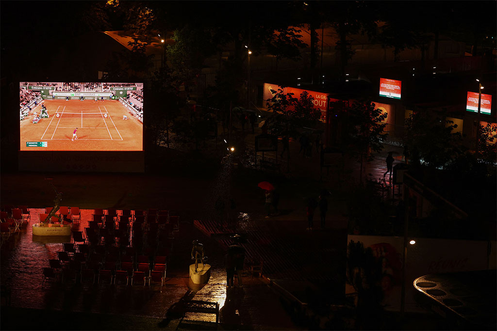 This general view shows a giant screen broadcasting the men's singles match between Japan's Yoshihito Nishioka and Serbia's Novak Djokovic on day two of the Roland-Garros Open tennis tournament in Paris on May 23, 2022. (Photo by Thomas SAMSON / AFP) (Photo by THOMAS SAMSON/AFP via Getty Images)