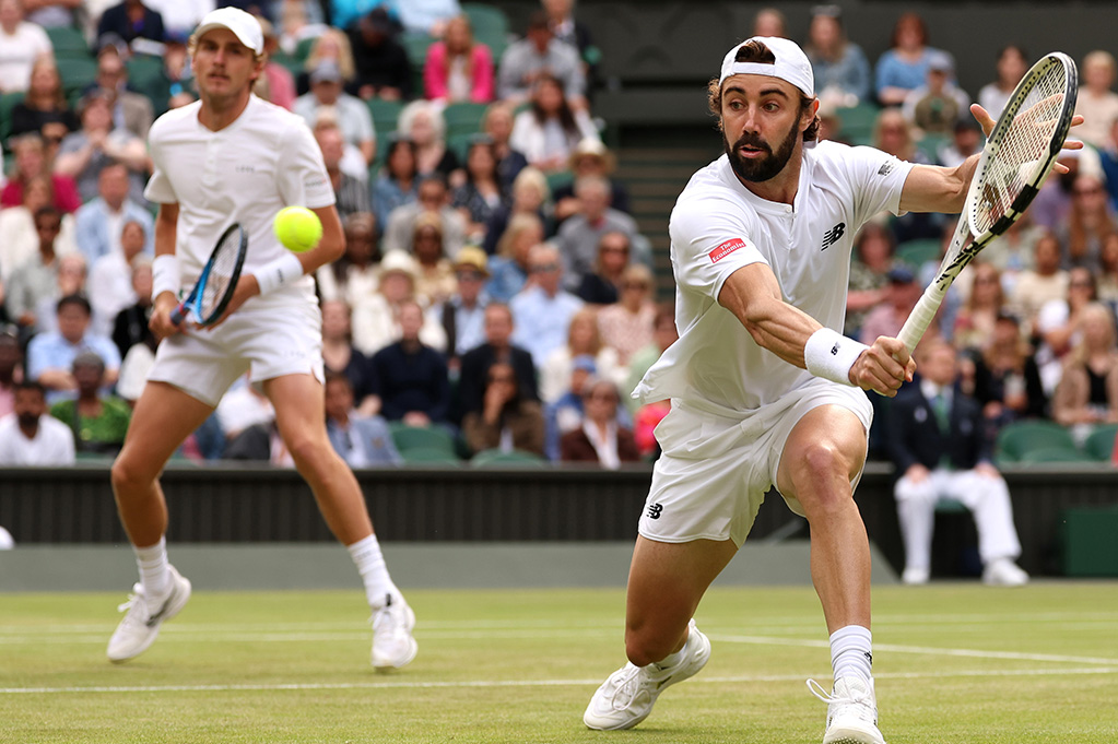 LONDON, ENGLAND - JULY 13: Jordan Thompson of Australia plays a backhand as he plays with Max Purcell of Australia against Harri Heliovaara of Finland and Henry Patten of Great Britain in the Gentlemen's Doubles Final during day thirteen of The Championships Wimbledon 2024 at All England Lawn Tennis and Croquet Club on July 13, 2024 in London, England. (Photo by Julian Finney/Getty Images)