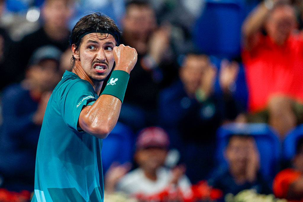 Australia's Alexei Popyrin reacts after a point against Italy's Jannik Sinner during their men's singles match at the Qatar Open tennis tournament in Doha on February 18, 2026. (Photo by Karim JAAFAR / AFP via Getty Images)