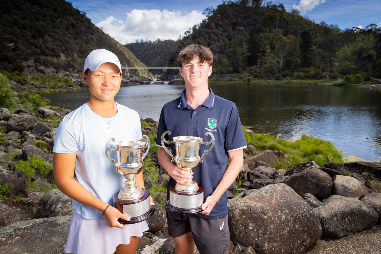 Emilie Chen and Luca Connaughton pose with trophies after winning 18/u Australian Tennis Championship singles titles. Photo credit: Tennis Tasmania 