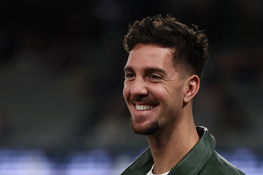 MELBOURNE, AUSTRALIA - MAY 24: Australian tennis player Thanasi Kokkinakis (left) watches on in the GWS guard of honour during the round 11 AFL match between Carlton Blues and Greater Western Sydney Giants at Marvel Stadium, on May 24, 2025, in Melbourne, Australia. (Photo by Morgan Hancock/Getty Images)