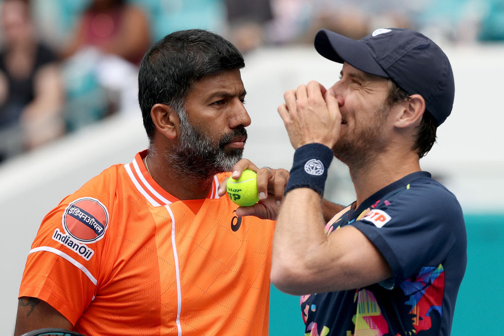 MIAMI GARDENS, FLORIDA - MARCH 30:  Rohan Bopanna of India and Matthew Ebden of Australia talk before serving to Austin Krajicek of the United States and Ivan Dodig of Croatia during the Men's Doubles Final at Hard Rock Stadium on March 30, 2024 in Miami Gardens, Florida. (Photo by Elsa/Getty Images)