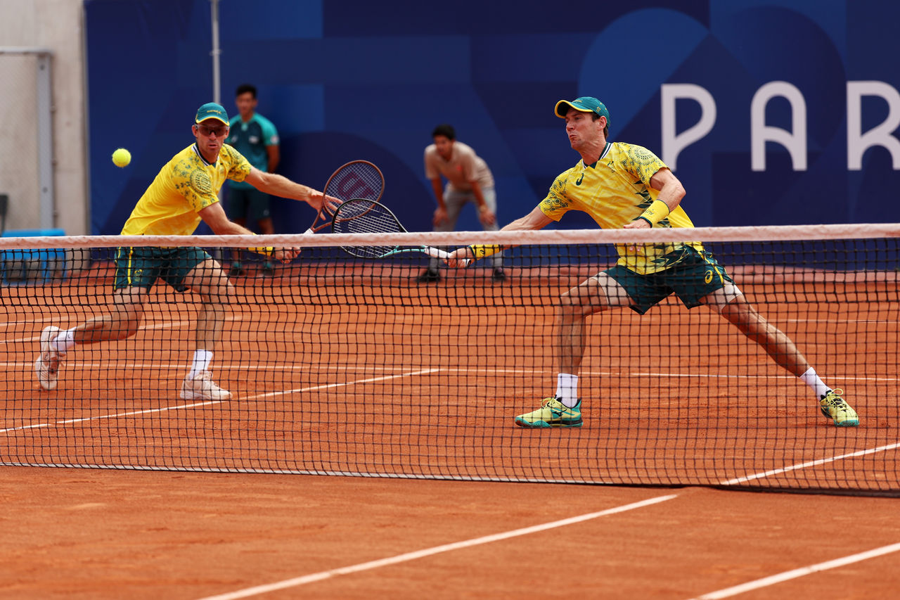 PARIS, FRANCE - JULY 31: Matthew Ebden of Team Australia and partner John Peers of Team Australia stretch for the same ball against Dominik Koepfer of Team Germany and Jan-Lennard Struff of Team Germany during the Men's Doubles Quarter-final match on day five of the Olympic Games Paris 2024 at Roland Garros on July 31, 2024 in Paris, France. (Photo by Julian Finney/Getty Images)