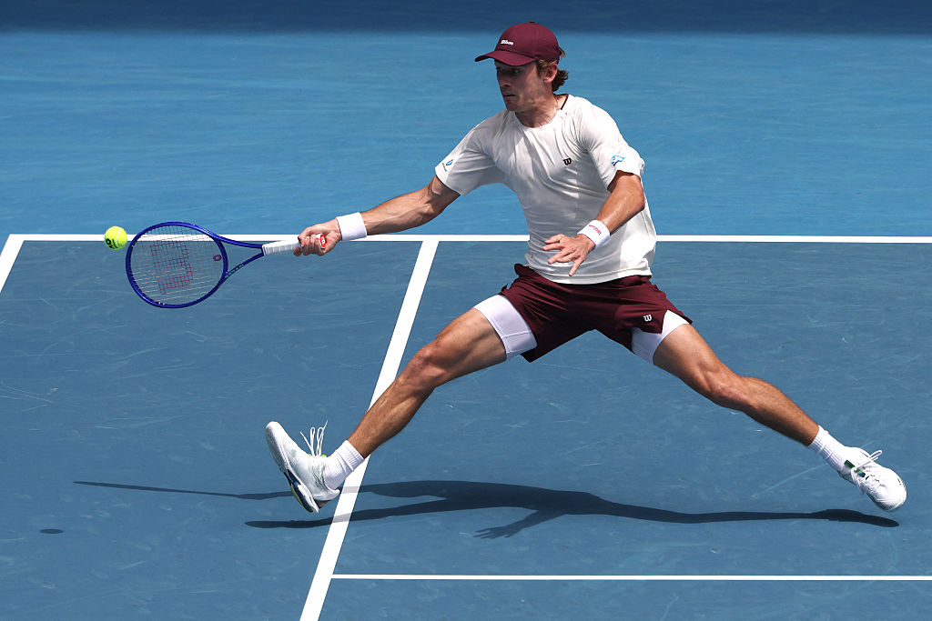 Australia's Alex De Minaur hits a return to USA's Mackenzie Mcdonald during their men's singles match on day two of the Australian Open tennis tournament in Melbourne on January 19, 2026. (Photo by DAVID GRAY / AFP via Getty Images) / -- IMAGE RESTRICTED TO EDITORIAL USE - STRICTLY NO COMMERCIAL USE --
