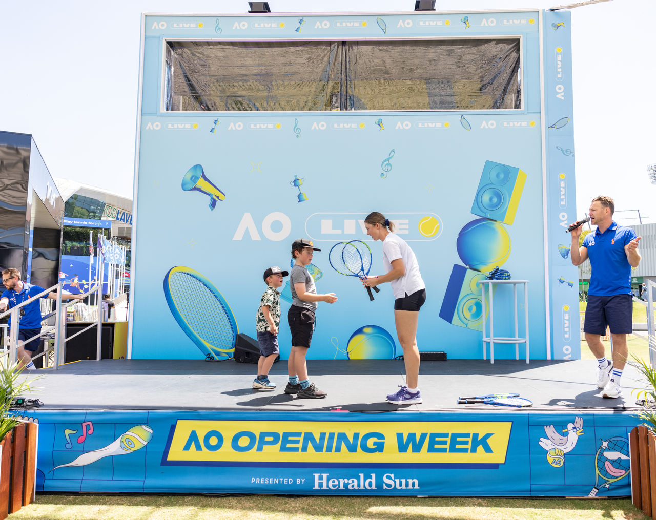 January 8:  Storm Hunter (AUS) gives away tennis racquets as part of AO Opening Week sponsored by Herald Sun at  the Fan Stage on Grand Slam Oval January 8, 2025. Photo by TENNIS AUSTRALIA/ FIONA HAMILTON
