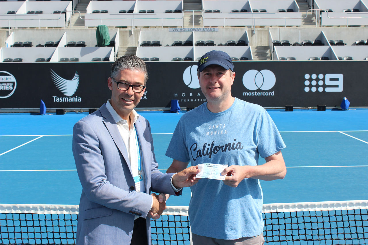 WINNER: Hobart International Tournament Director Darren Sturgess with competition winner Stuart Geeves. Picture: Joe Turmine