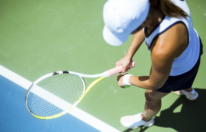 Beautiful female tennis player serving outdoor and a closeup of the serve from above