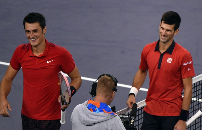 Bernard Tomic (L) and Novak Djokovic share a nice moment at net after Djokovic won their Shanghai Masters quarterfinal; Getty Images