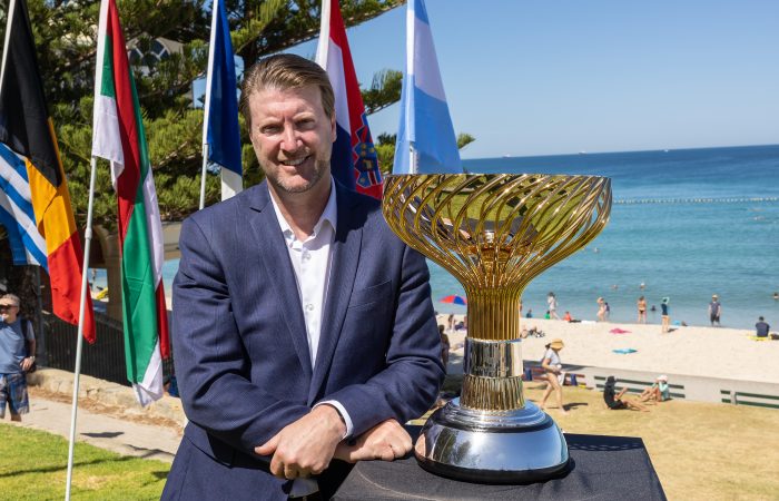 PERTH, AUSTRALIA - DECEMBER 20: Brett Patten (United Cup Perth General Manager) poses with the trophy during a United Cup media opportunity at Cottesloe Beach on December 20, 2022 in Perth, Australia. (Photo by Paul Kane/Getty Images for Tennis Australia)