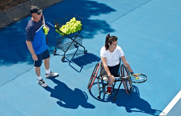 Coach Greg Crump passes on some tips to a wheelchair tennis player. TENNIS AUSTRALIA