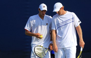 Chris Guccione and Carsten Ball talk tactics in a double match.