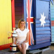 Clijsters poses with her Australian Open 2011 trophy at Brighton Beach.