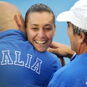 Flavia Pennetta is embraced by members of the Italian entourage following her win over Sam Stosur. AFP