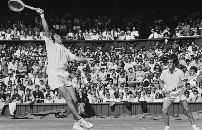 Ken Fletcher (left) flies for a smash while John Newcombe looks on. HULTON ARCHIVE