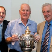 Author Richard Naughton, Wimbledon champion Neale Fraser and Sir Norman Brookes's grandson Norman Gengoult-Smith with Brookes' Wimbledon trophy. MAE DUMRIGUE