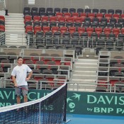 Pat Rafter, Lleyton Hewitt and Tony Roche watch a Davis Cup practice session at the Queensland Tennis Centre. 