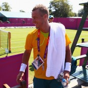 Lleyton Hewitt leaves the court in good spirits after a practice session ahead of the 2012 London Olympic Games at Wimbledon; Getty Images