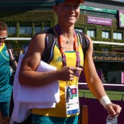 Sam Stosur, followed by coach David Taylor, arrives for a practice session ahead of the 2012 London Olympic Games at Wimbledon in London, England; Getty Images