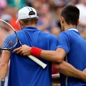 Clad in their similar national colours, Andy Roddick (L) of the United States and Novak Djokovic of Serbia embrace after their second round match on Wimbledon's Centre Court at the Olympic tennis event, which Djokovic won in straight sets; Getty Images