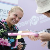 Sabine Lisicki, dressed in a 'Yukata' summer kimono, shakes hands with a fan at an autograph session during the Toray Pan Pacific Open in Tokyo, Japan. Lisicki fell in the opening round to Heather Watson; Getty Images