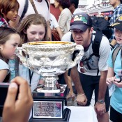 Fans intently inspect the detail on the Norman Brookes Challenge Cup in Tokyo as part of the AO Trophy Tour; Keith Tsuji