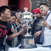 Fans pose with the Daphne Akhust Memorial Cup in Tokyo as part of the AO Trophy Tour; Keith Tsuji