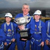 Ken Rosewall (centre) and (L-R) Tristan Dardis, Kate Stanbridge, Ella Lanigan and Harrison Garrett from Mosman Lawn Tennis Club pose with the Norman Brookes Challenge Cup during the Australian Open Trophy Tour at Sky Walk, Sydney Tower in Sydney, Australia; Getty Images