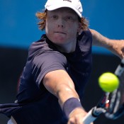 Matthew Barton of Australia plays a backhand volley in his first round qualifying match at Australian Open 2013.