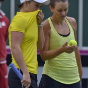 Ashleigh Barty (L) and Casey Dellacqua discuss tactics during their Fed Cup doubles rubber against Czechs Andrea Hlavackova and Lucie Hradecka; Martin Sidorjak, Tennis Arena