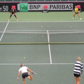 Sam Stosur (bottom left) and Alicia Molik (bottom right) serve to Jarmila Gajdosova (top left) and Ashleigh Barty during the Australian Fed Cup team practice session at Cez Arena in Ostrava ahead of the Australia v Czech Republic Fed Cup World Group first round tie; Tennis Australia