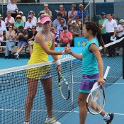 Storm Sanders (L) shakes hands with Shuko Aoyama after defeating the Japanese 6-4 6-4 to win the Launceston Women's Pro Tour event; Denis Tucker