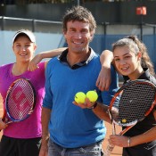Pat Cash poses with 2012 Gallipoli Youth Cup winner Ellen Perez (L) and Sera Yavuzcan (R) at the clay courts at Melbourne Park's National Tennis Centre; Tennis Australia